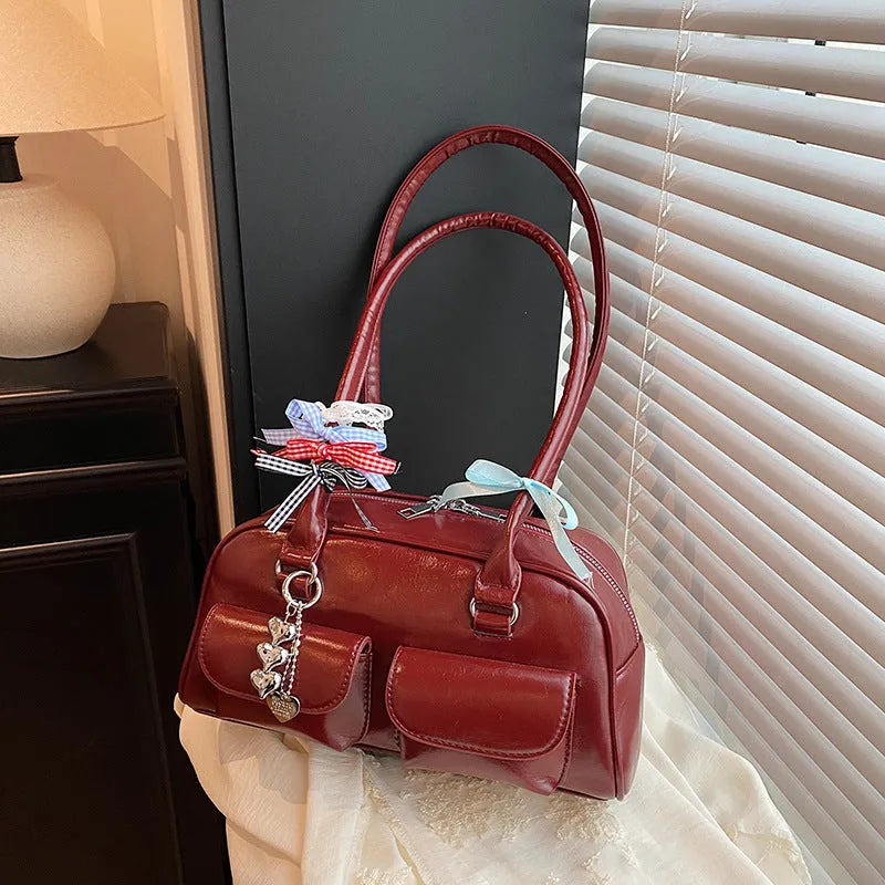 Retro brown PU leather women's pillow handbag with a flap and double shoulder strap on a neutral background.