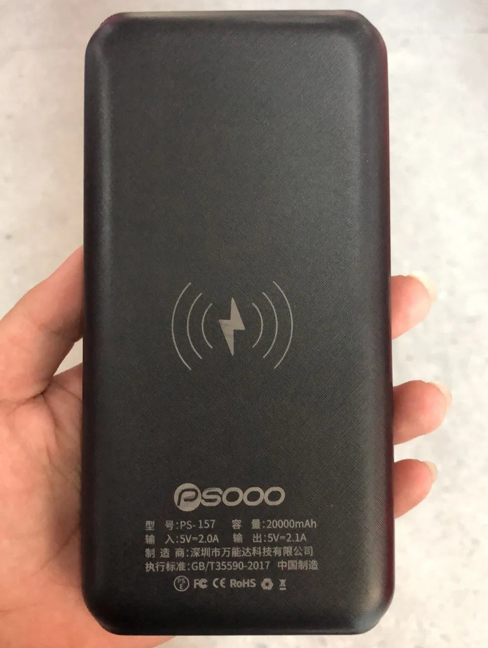 Black wireless solar power bank with Qi charging pad, three USB ports and an LED flashlight