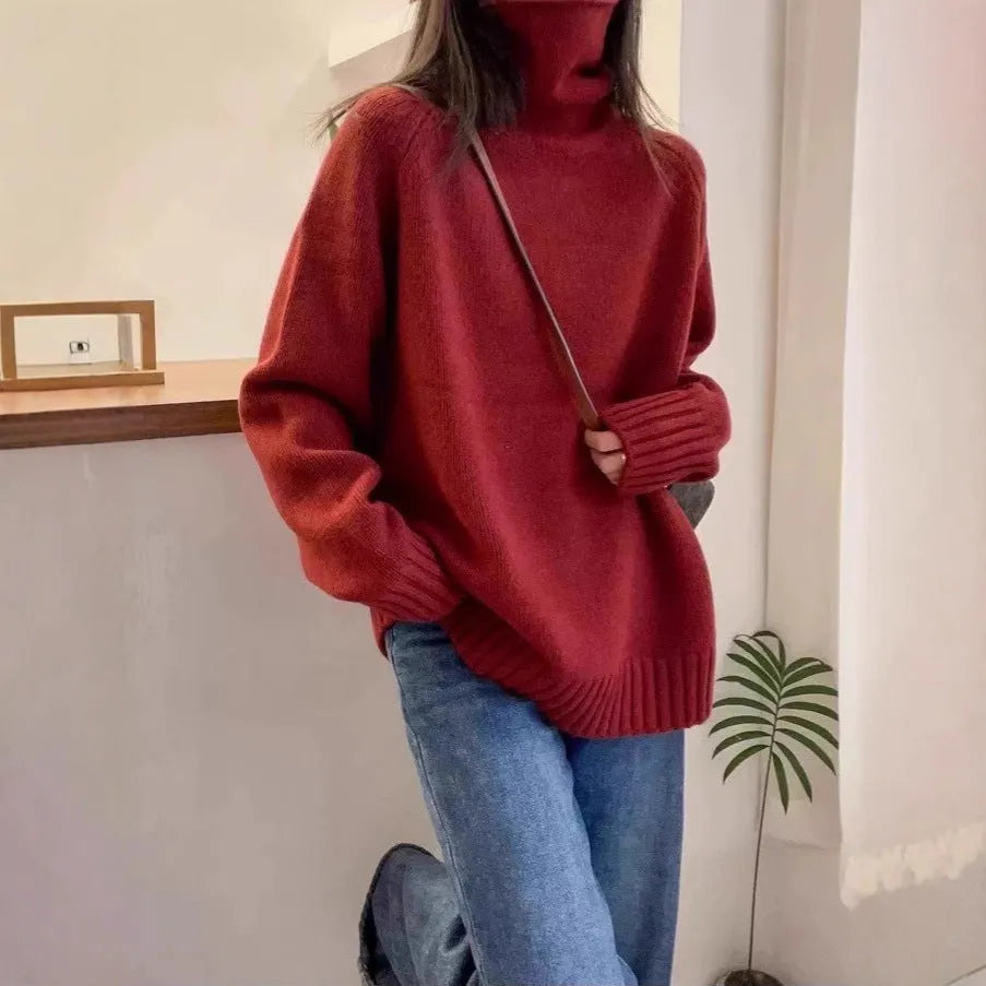 Red women's loose turtleneck sweater with a thick, textured curling pile collar.