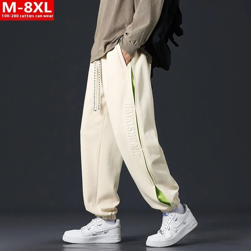 Men's loose fit cotton trousers with banded ankles and stitching details in grey green colour
