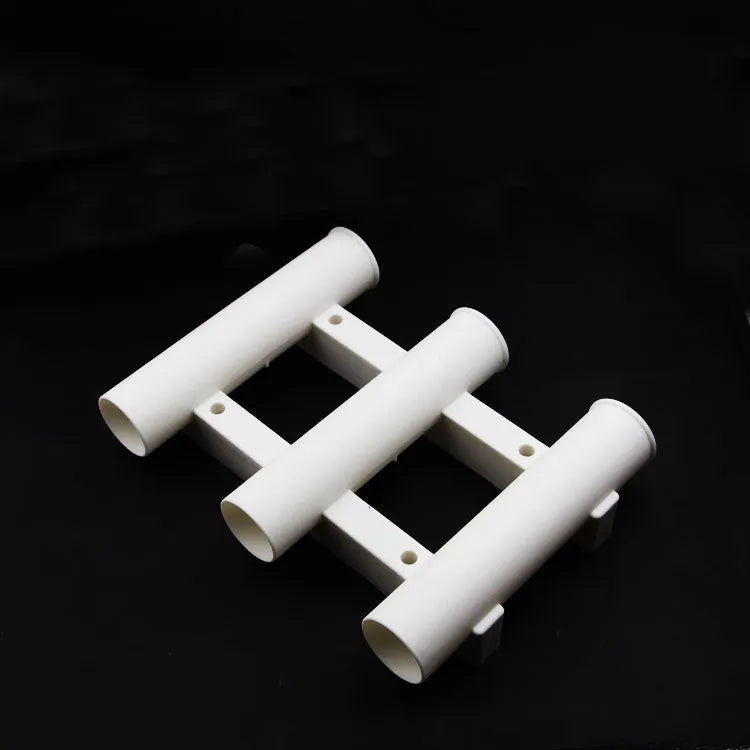 Black sea fishing rod turret with 3 holes and 6 extension screws on a sandy beach