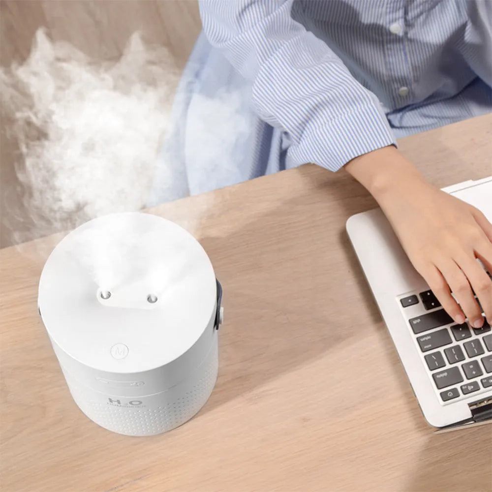 Green wireless bedroom humidifier with colour-changing light and USB port on a bedside table