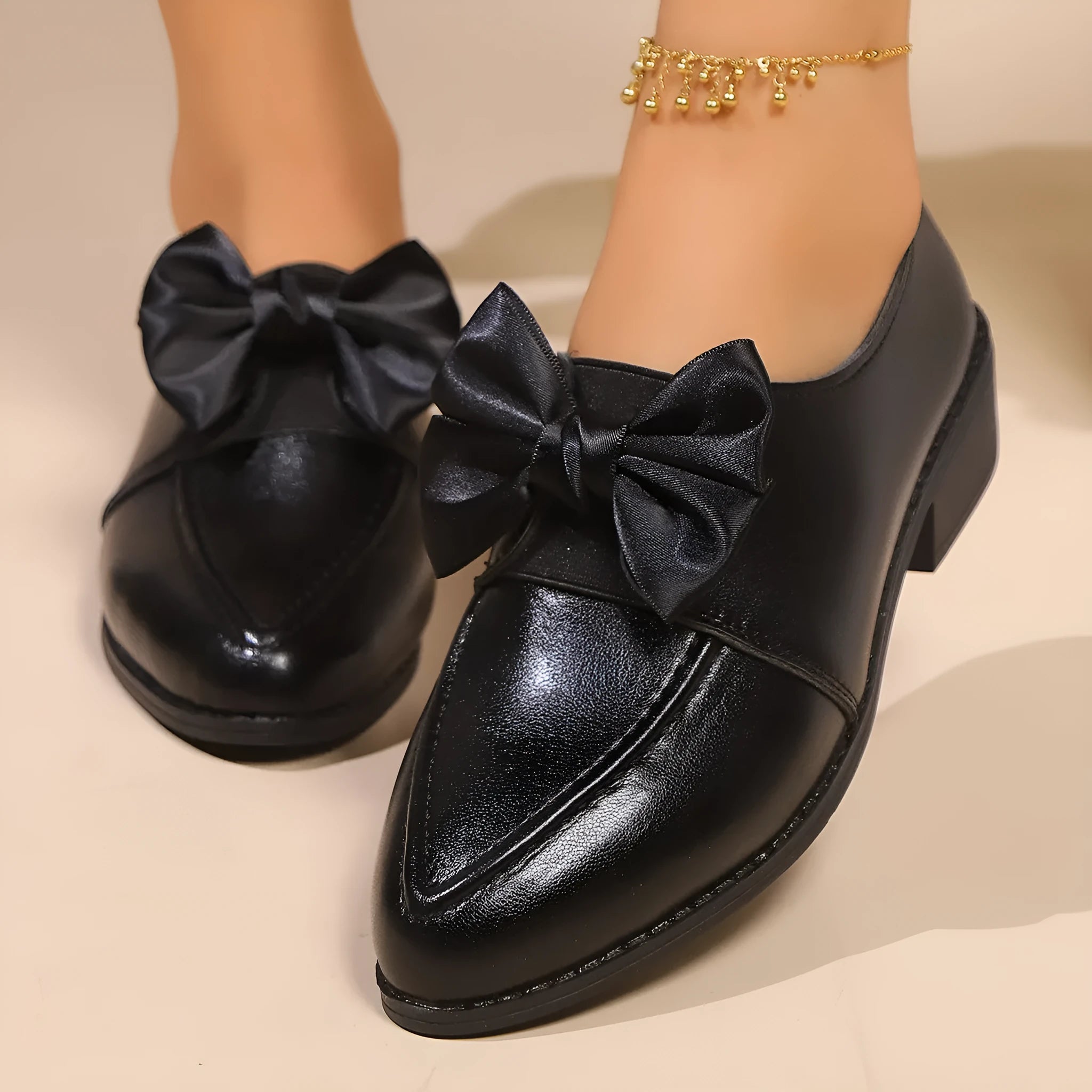 Women's British-style leather shoes with a decorative bow, rubber sole, and pointed toe.