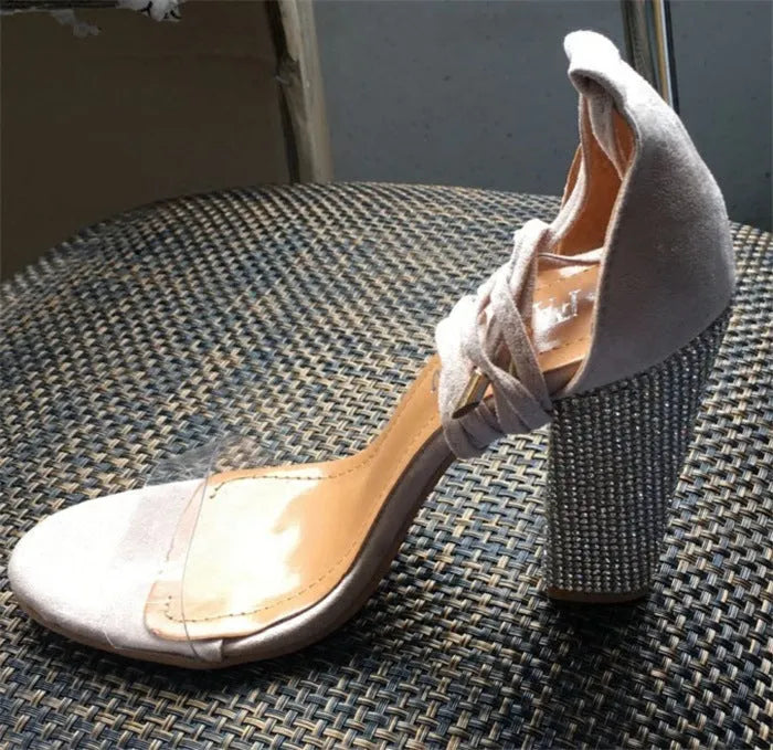 Plastic high heels with pointed toe in black and gold colours showing European American style