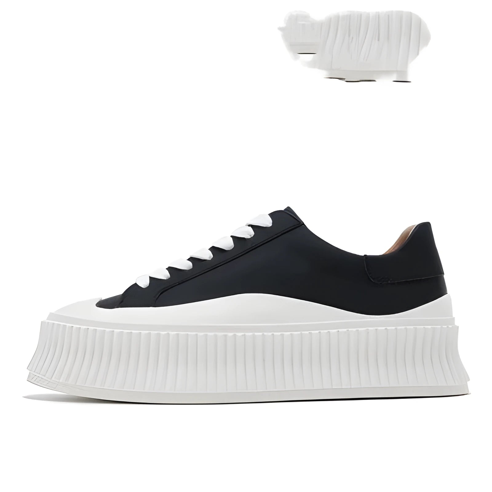 Women's black suede platform sneakers with back lacing, cross binding detail, and a thick sole on a white background.