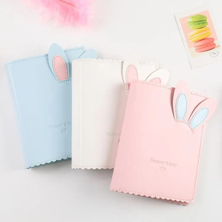 Mini rabbit style photo album in three colours showing loose-leaf design for 3-inch photographs