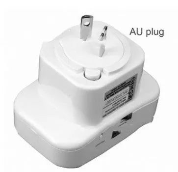 Black and white WiFi signal repeater with UK plug and international adapters showing compact size