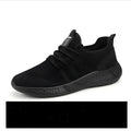 Men's black and white mesh sneakers with round toe and lace-up fastening