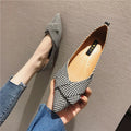 Women's red and black pointed-toe low-heel flats with a shallow mouth opening, shown from the side.