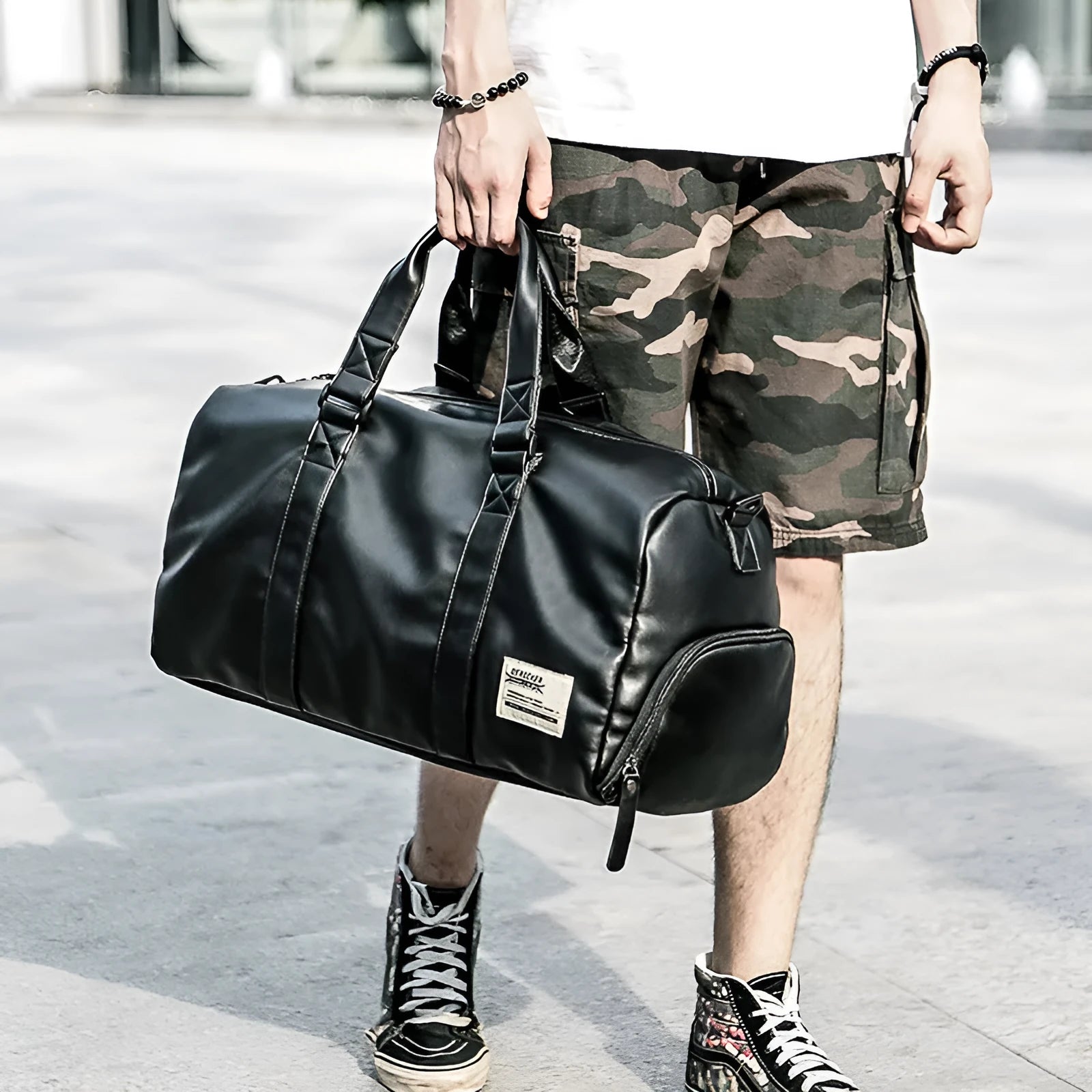 Black large capacity PU leather sports training bag with a single strap and multiple internal compartments.