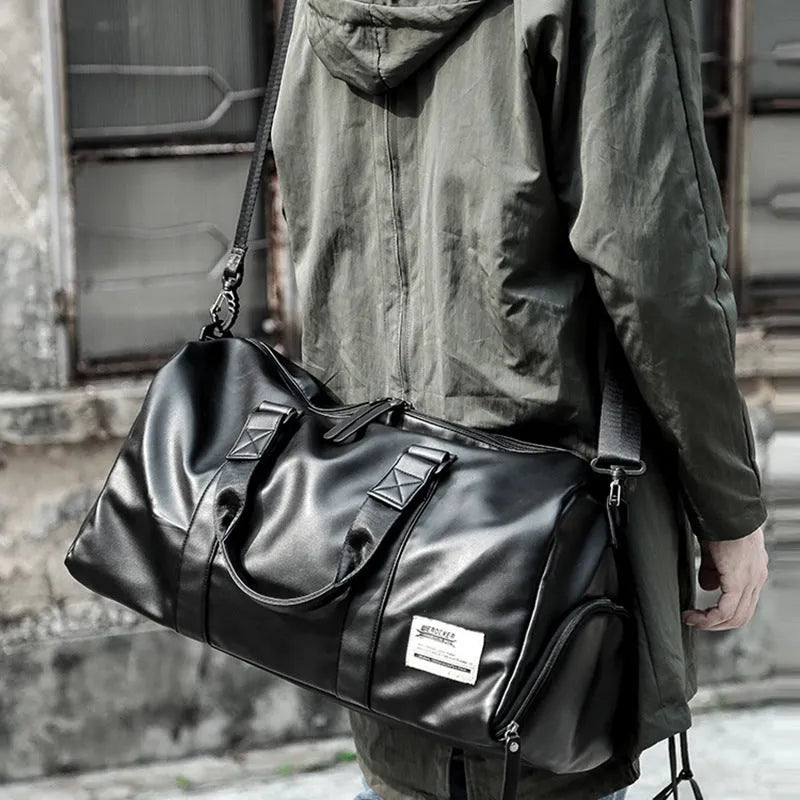 Black large capacity PU leather sports training bag with a single strap and multiple internal compartments.