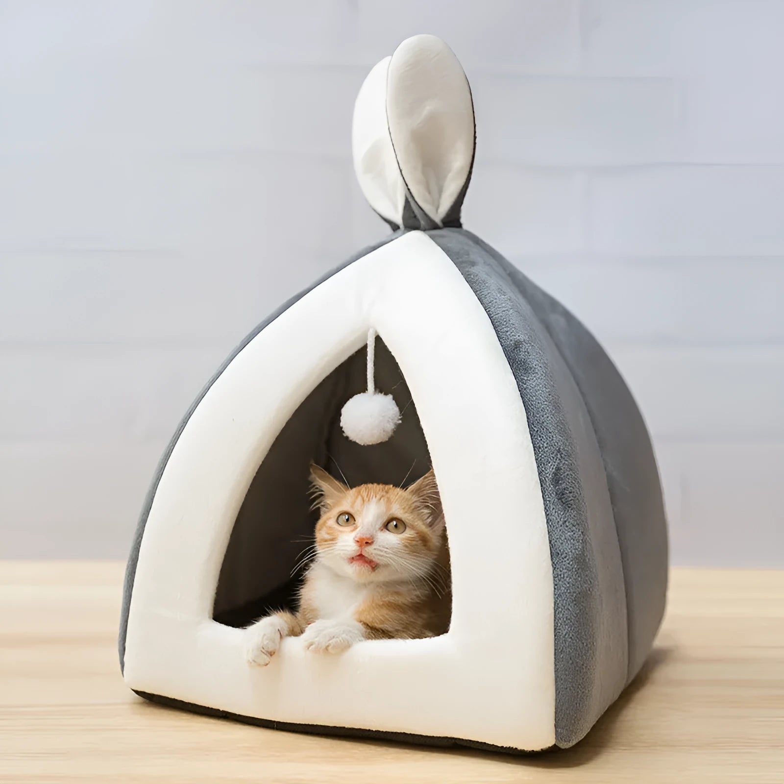 Grey fabric cat house with plush interior shown in medium size