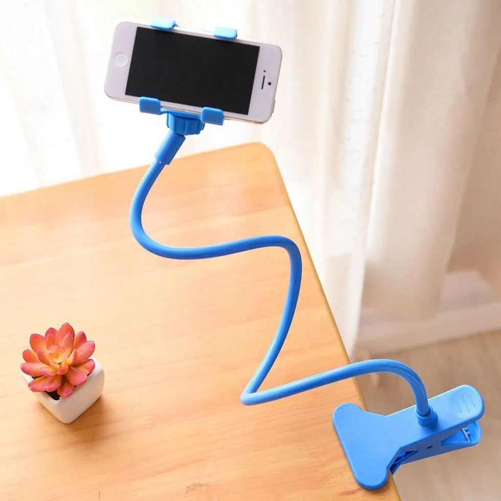 Black flexible long arm phone holder with V-clip attached to a bed frame, holding a smartphone.