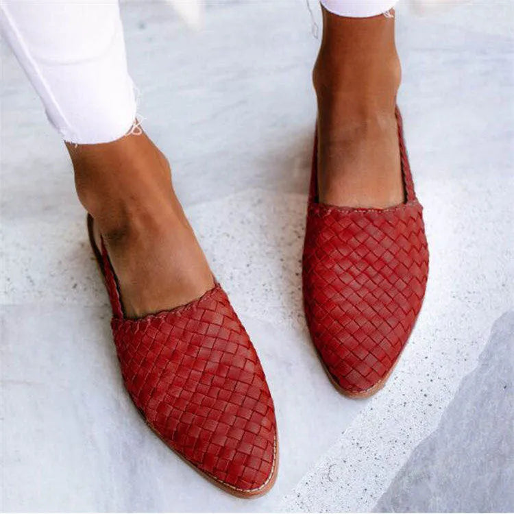 A pair of flat buckle sandals with a pointed toe, shown in one of the available colours.