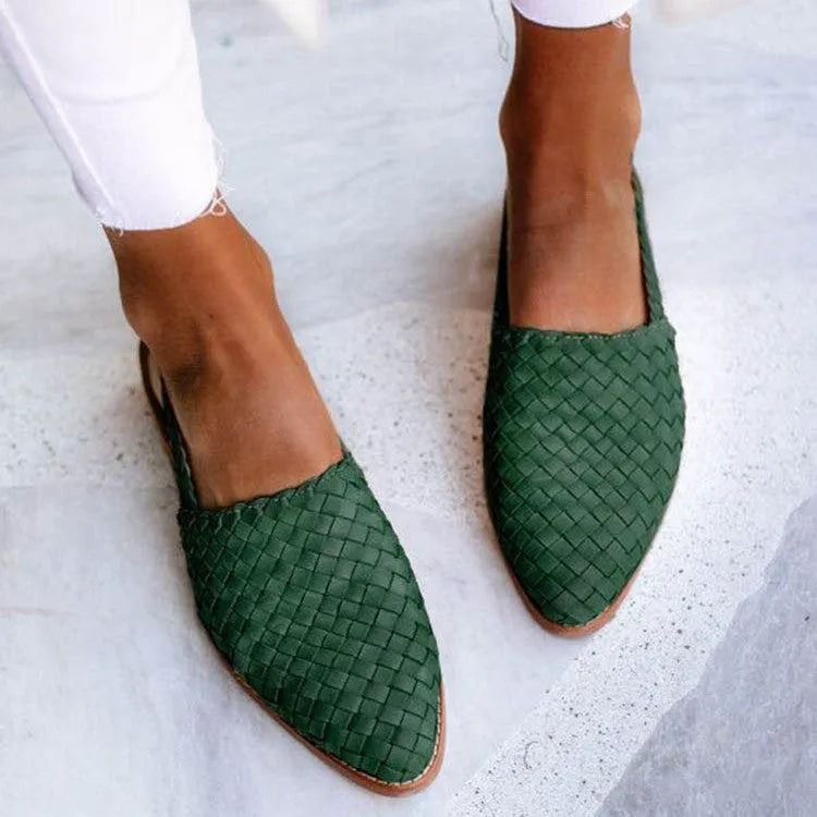 A pair of flat buckle sandals with a pointed toe, shown in one of the available colours.
