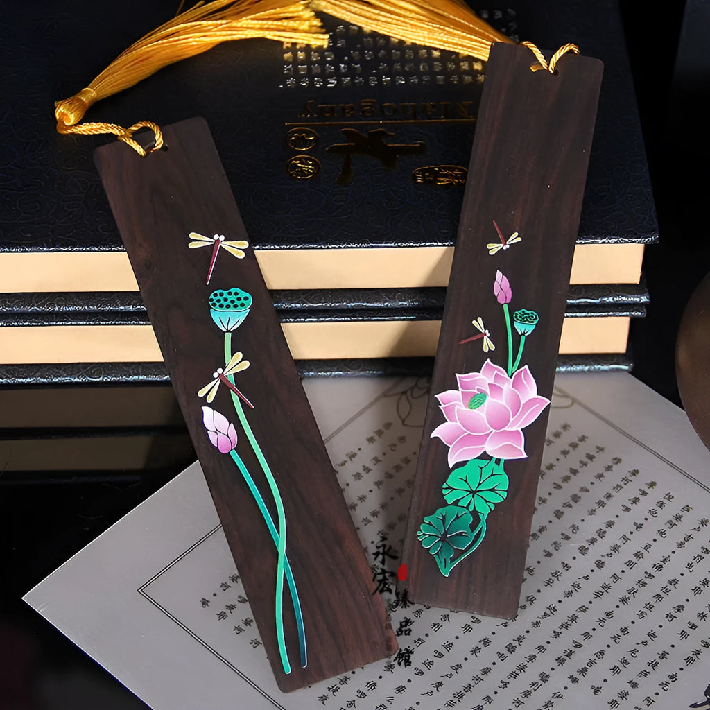 Painted lotus bookmark set in sandalwood with two designs showing landscape and flower patterns