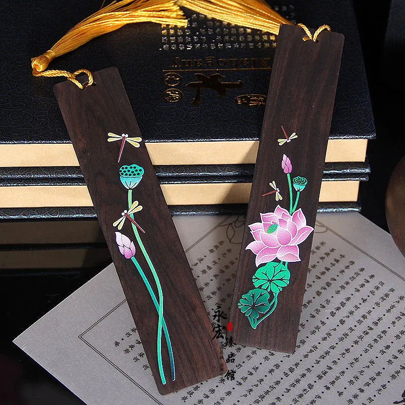Painted lotus bookmark set in sandalwood with two designs showing landscape and flower patterns