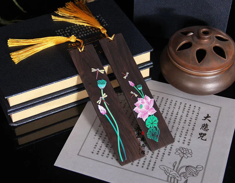 Painted lotus bookmark set in sandalwood with two designs showing landscape and flower patterns