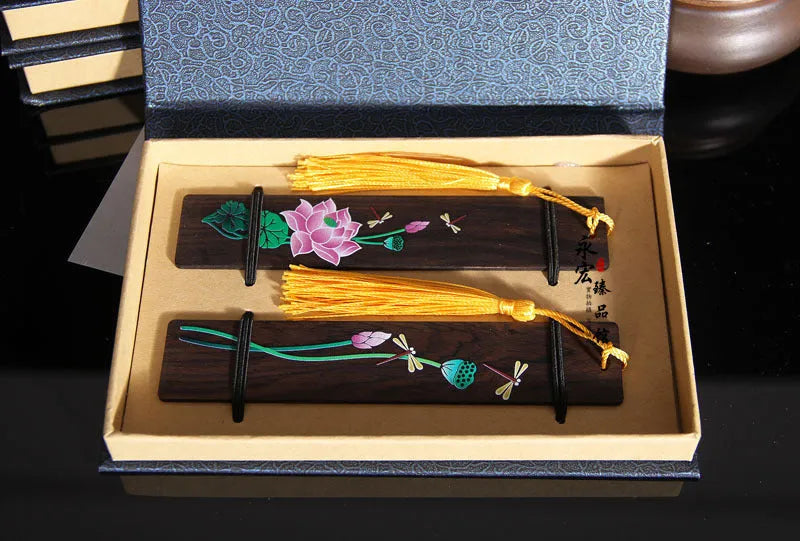 Painted lotus bookmark set in sandalwood with two designs showing landscape and flower patterns