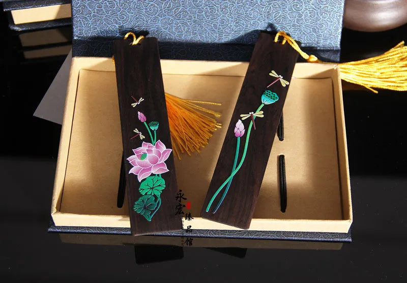 Painted lotus bookmark set in sandalwood with two designs showing landscape and flower patterns