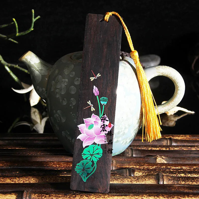 Painted lotus bookmark set in sandalwood with two designs showing landscape and flower patterns