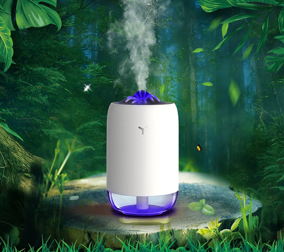 Magic Flame columnar humidifier in light blue on a wooden desk, showing USB cable and single mist outlet.