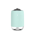 Magic Flame columnar humidifier in light blue on a wooden desk, showing USB cable and single mist outlet.
