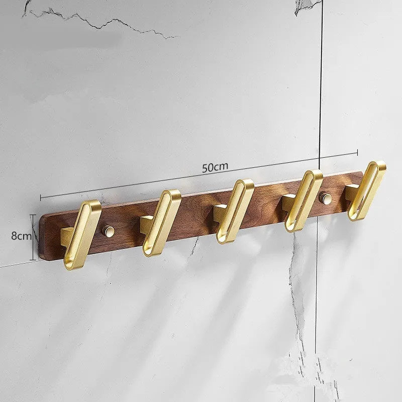 Black walnut bathroom clothes hook row with brass-finished aluminium hooks in perforated mounting design