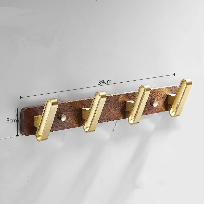 Black walnut bathroom clothes hook row with brass-finished aluminium hooks in perforated mounting design