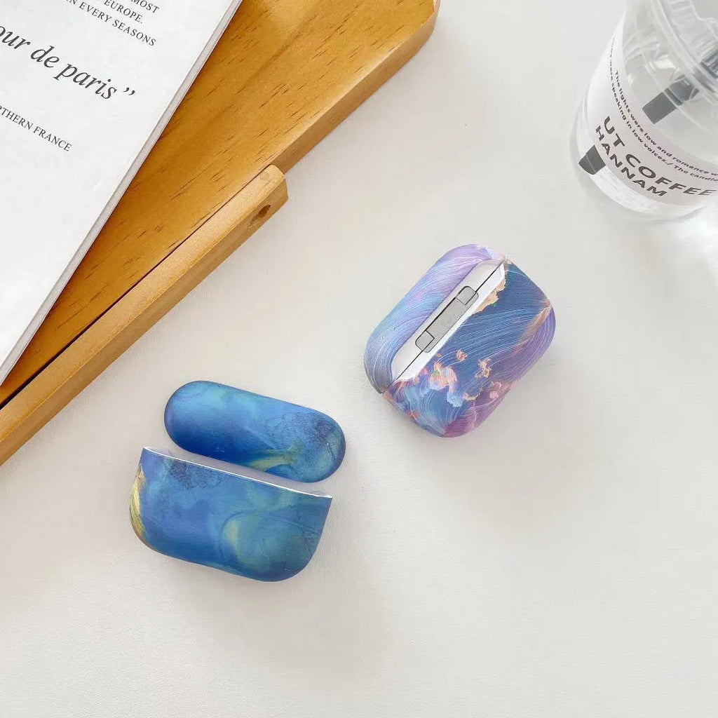 Hard plastic protective case for AirPods with pink and blue watercolour design.