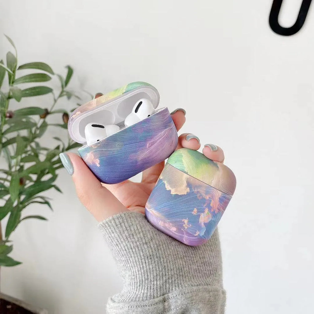 Hard plastic protective case for AirPods with pink and blue watercolour design.