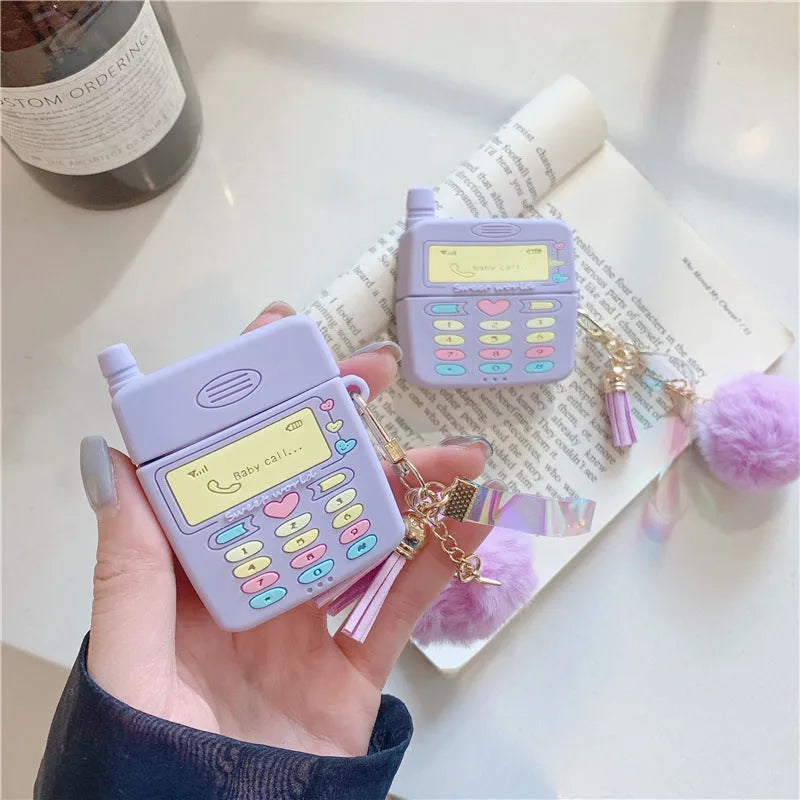 Purple silicone AirPods case with clamshell design and fur ball pendant