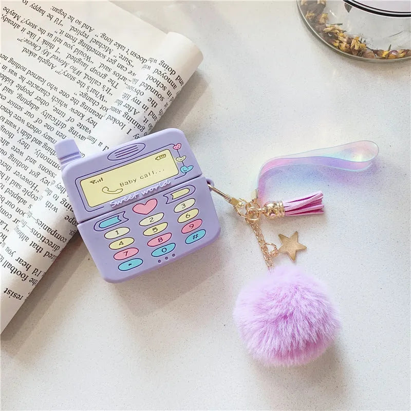 Purple silicone AirPods case with clamshell design and fur ball pendant