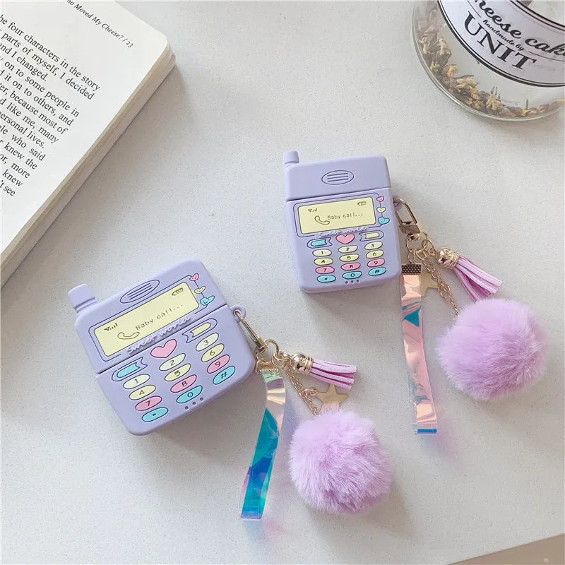 Purple silicone AirPods case with clamshell design and fur ball pendant