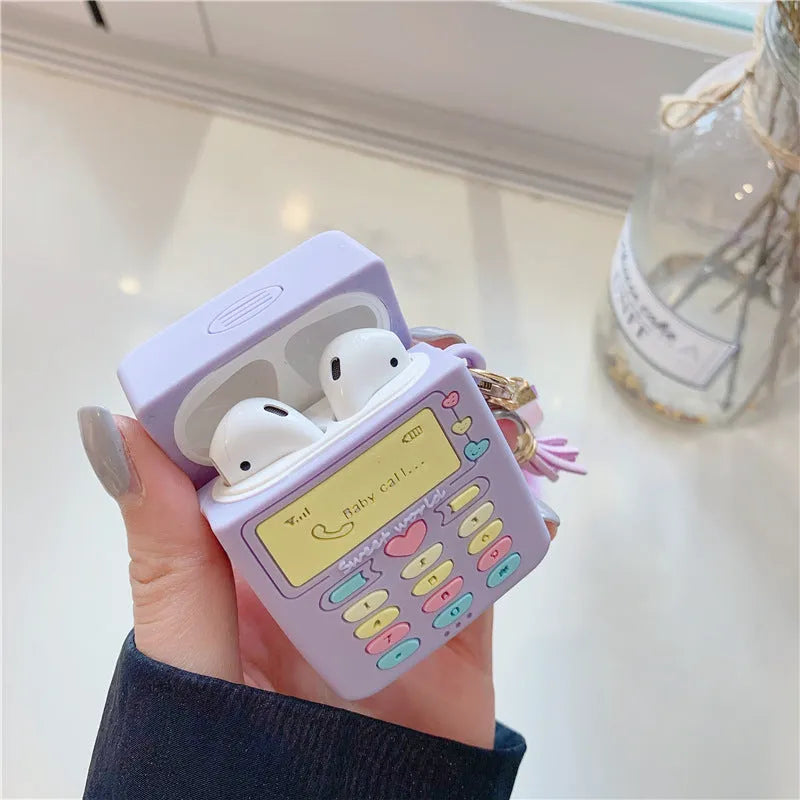 Purple silicone AirPods case with clamshell design and fur ball pendant