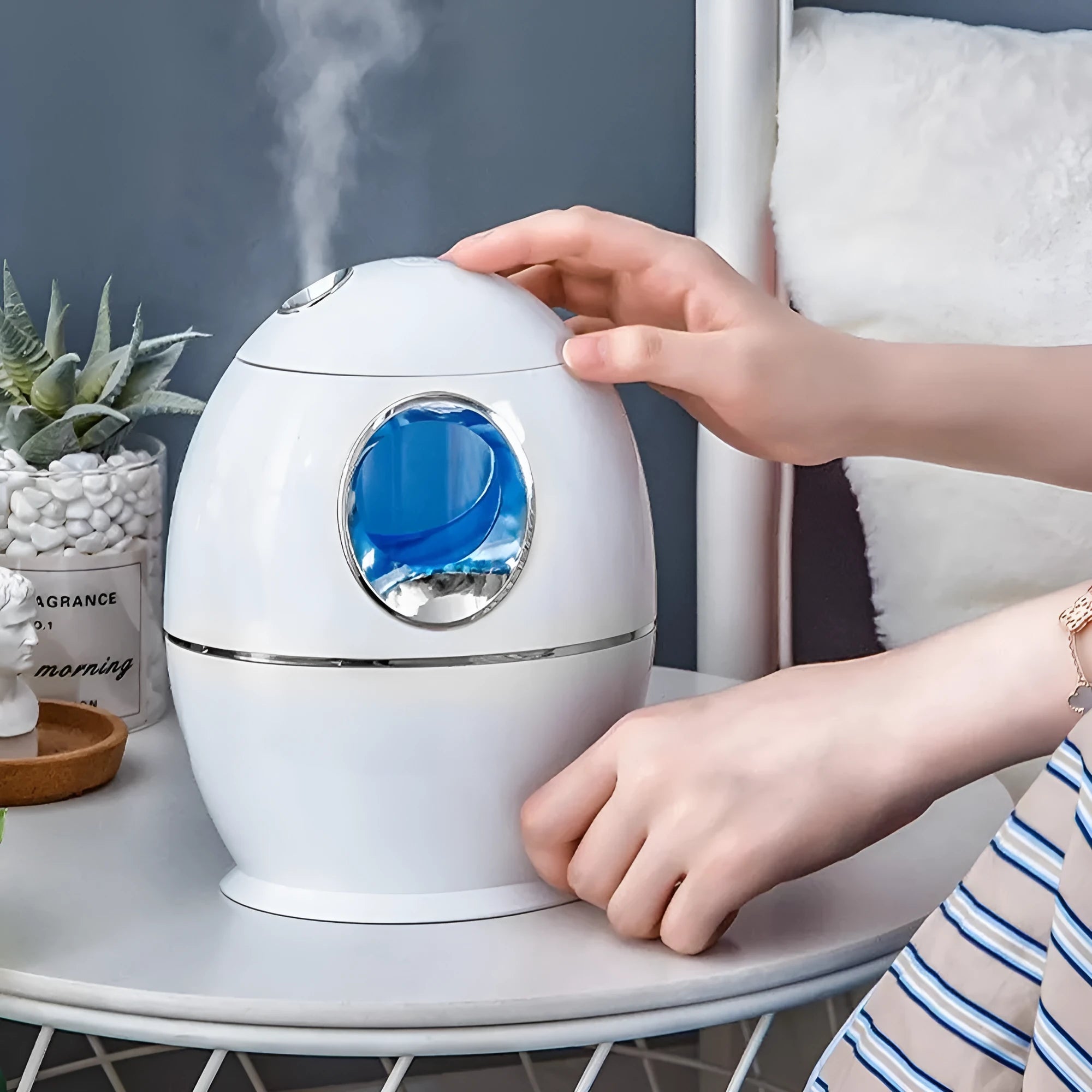 White round USB-powered aromatherapy spray humidifier on a table.