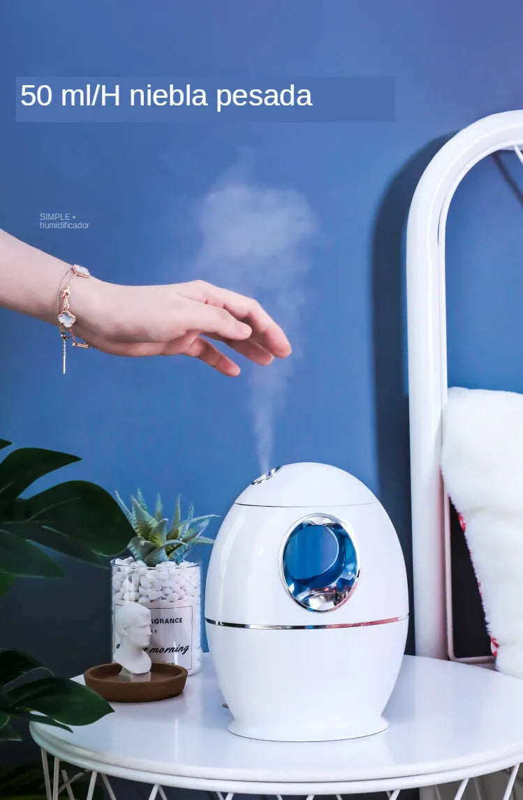 White round USB-powered aromatherapy spray humidifier on a table.