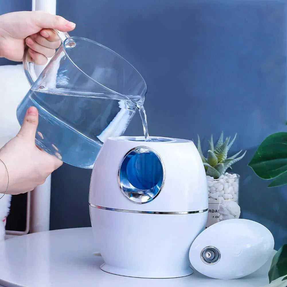 White round USB-powered aromatherapy spray humidifier on a table.