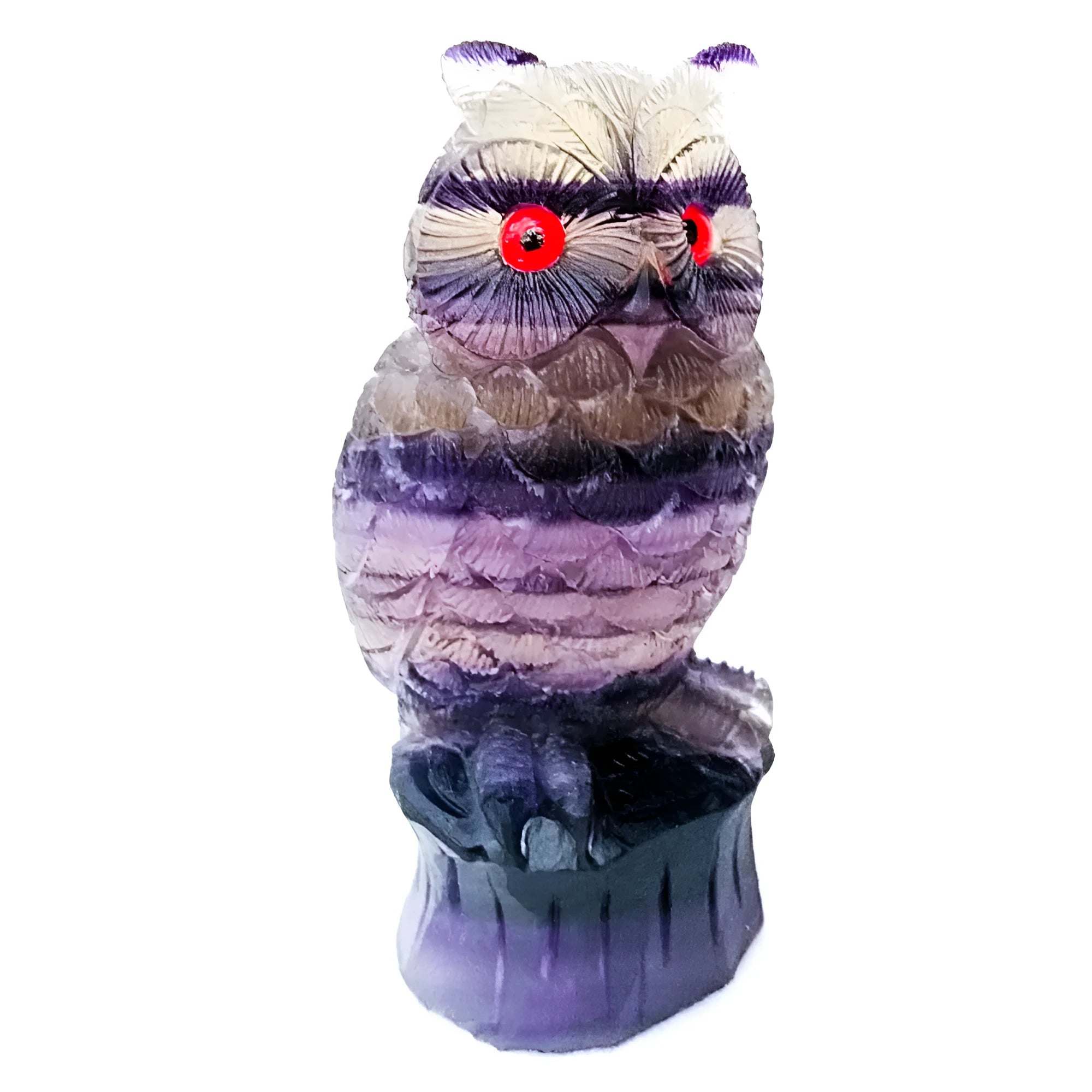 Hand carved purple fluorite stone owl ornament on a wooden surface.