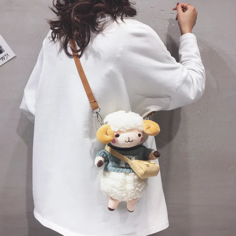Small blue plush crossbody bag with a lamb pattern and zip pocket.