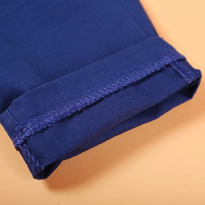 Blue boys' smart clothing set on hanger showing turtleneck, waistcoat, trousers, and tie.