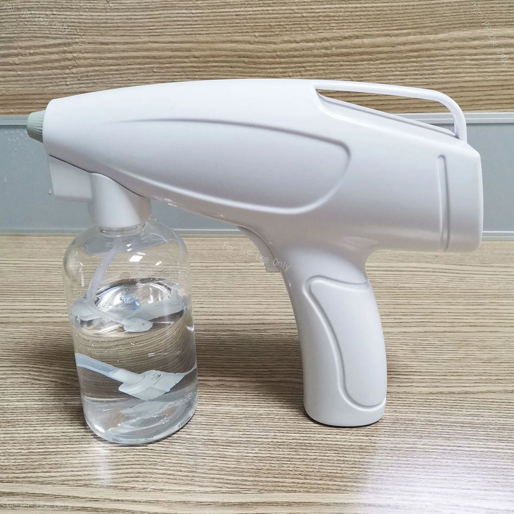 White handheld cordless electric spray gun with USB charging cable on a white background.