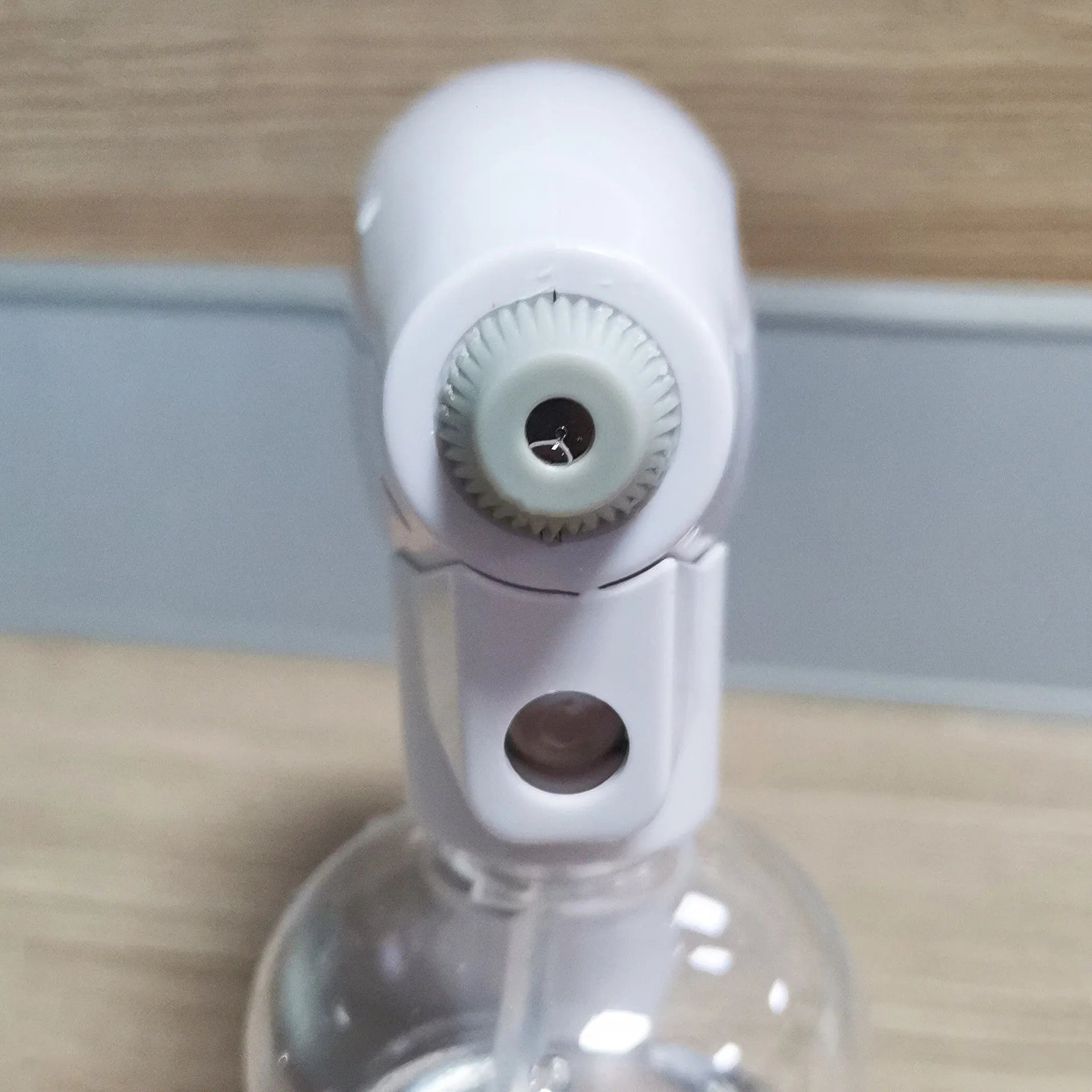 White handheld cordless electric spray gun with USB charging cable on a white background.