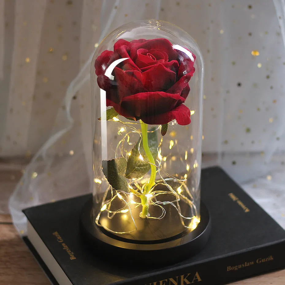 Silk rose bouquet with LED lights and glass shade in scarlet colour on wooden base