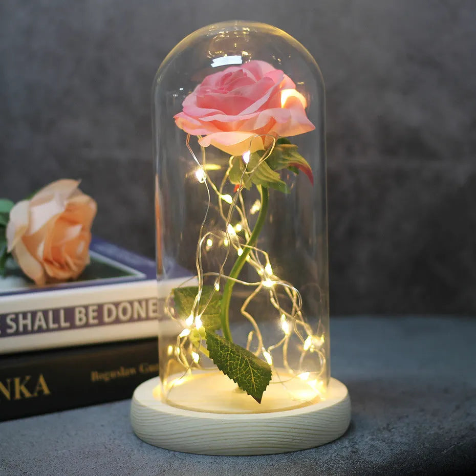 Silk rose bouquet with LED lights and glass shade in scarlet colour on wooden base