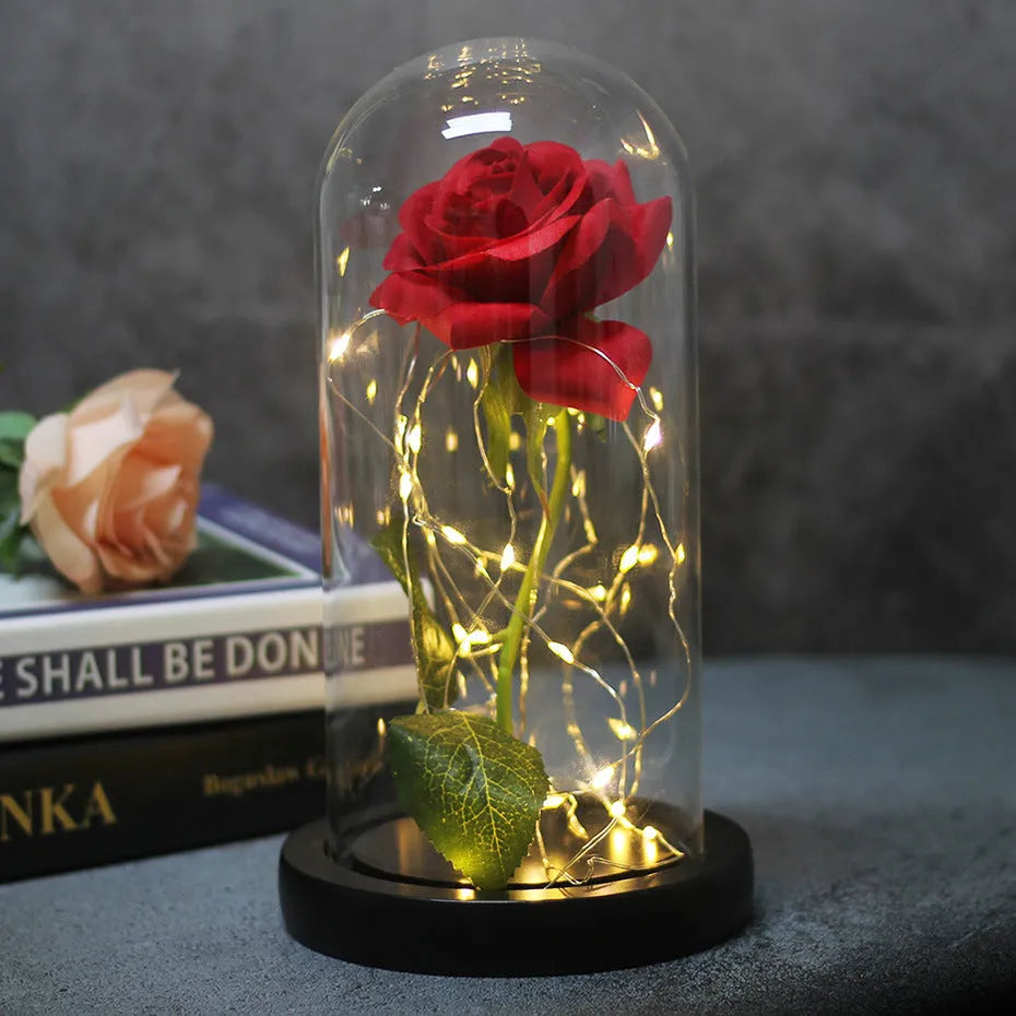 Silk rose bouquet with LED lights and glass shade in scarlet colour on wooden base