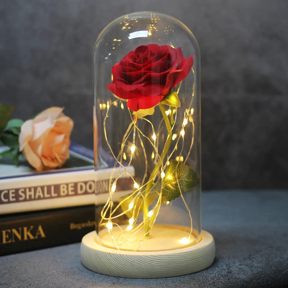 Silk rose bouquet with LED lights and glass shade in scarlet colour on wooden base