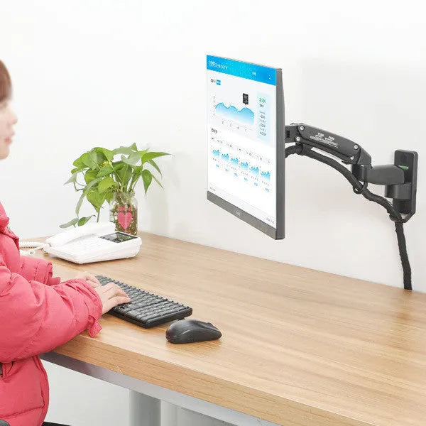 Black aluminium wall-mounted monitor stand extended from the wall with screen attached