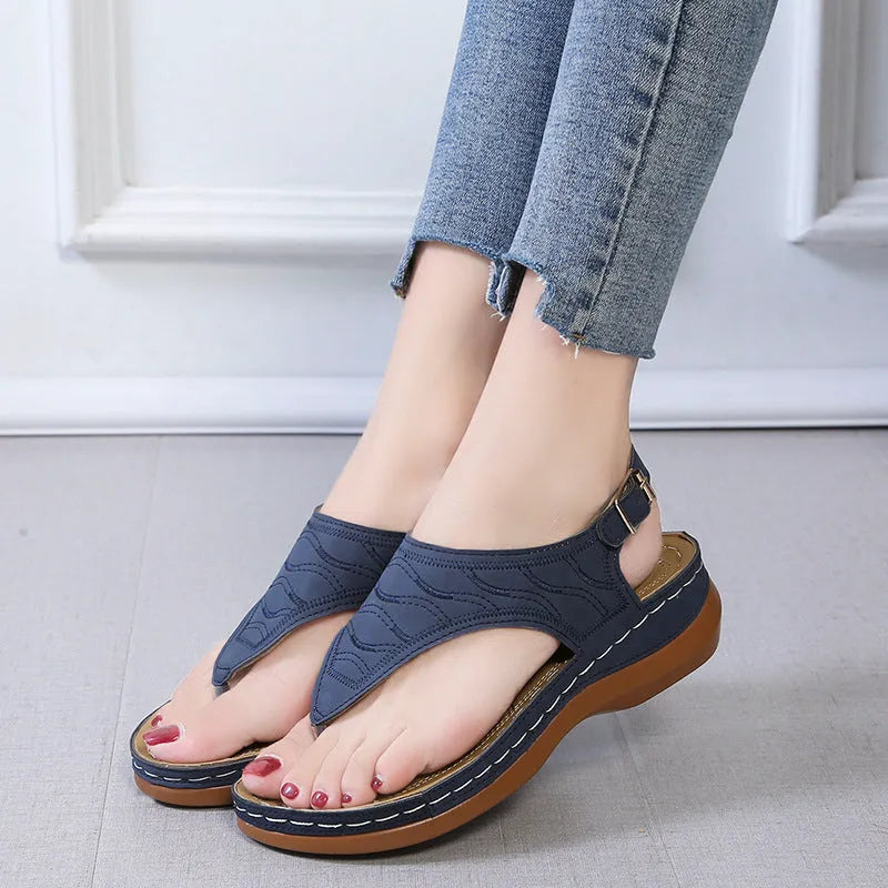 Women's casual wedge heel flip flop sandals with an adjustable buckle strap in black.