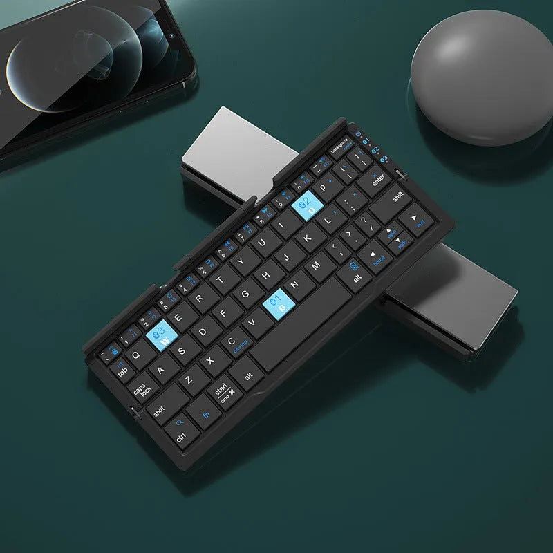 Silver white folding Bluetooth keyboard with hidden stand supporting smartphone, shown open and closed
